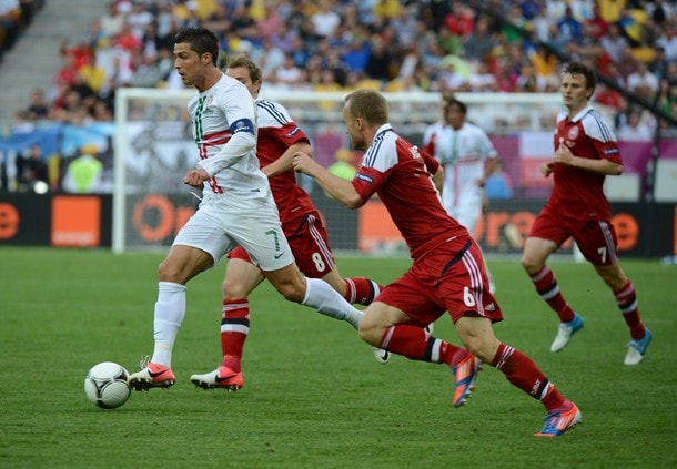 Portuguese forward Cristiano Ronaldo (C) tries to break away from Denmark's defence during the Euro 2012 championships football match Denmark vs Portugal on June 13, 2012 at the Arena Lviv.