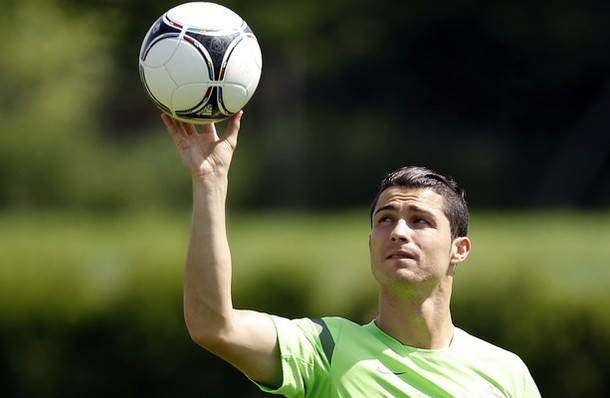 Portugal's Cristiano Ronaldo holds a ball during a training session of Portugal, prior to their Euro 2012 soccer semifinal match, in Opalenica, Poland, Saturday, June 23, 2012.