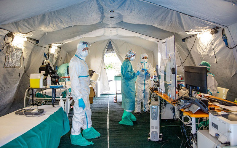 Các nhân viên y tế làm việc bên trong một lều phân loại tại một bệnh viện ở Italy trong đợt dịch Covid-19