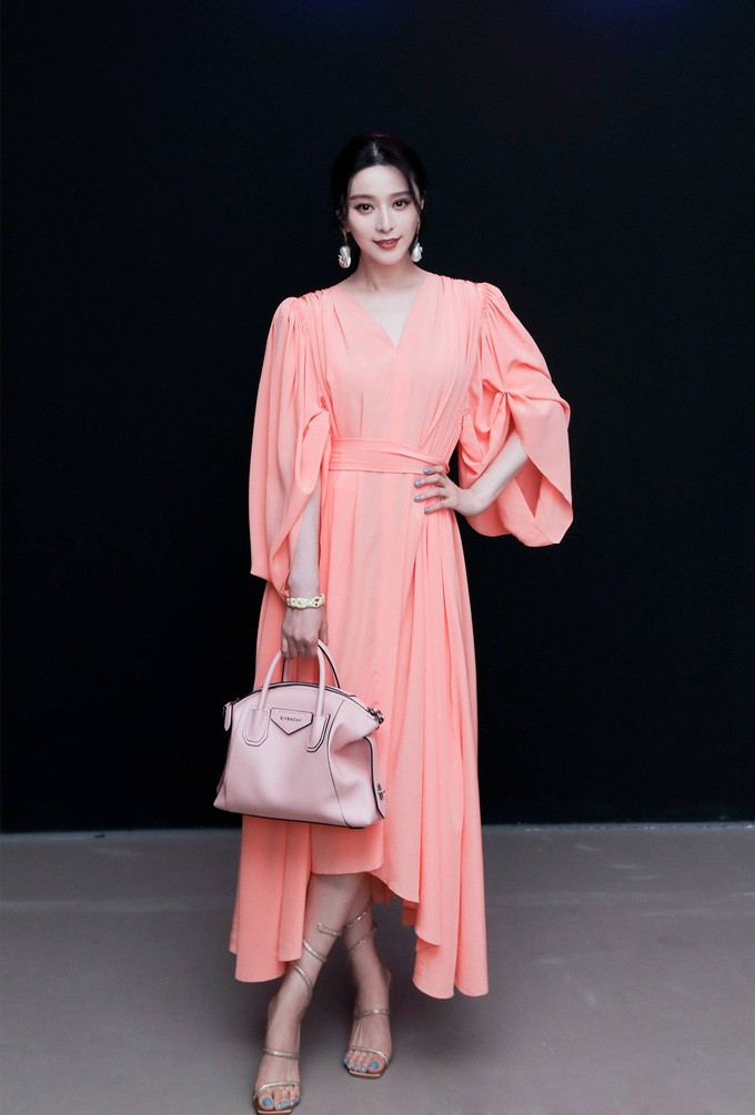 Phạm Băng Băng dự triển lãm The light/Spectrum vào tối 23/7 với váy hồng trong bộ sưu tập Pre-Fall 2020 của nhà mốt Givenchy. Cô kết hợp túi xách dòng Antigona cùng thương hiệu, giày René Caovilla, đeo hoa tai Minh Song Haute Joaillerie.
