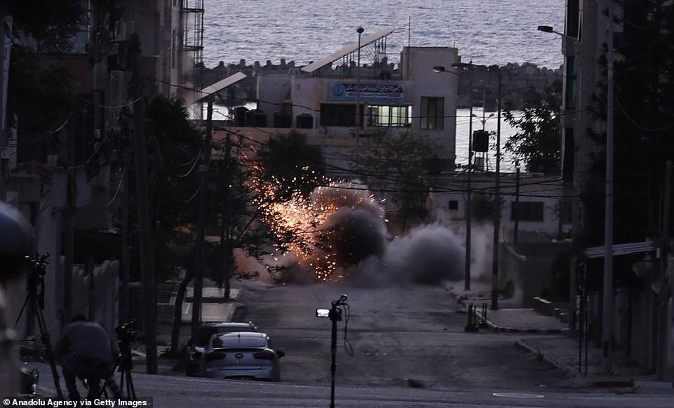 42861762-9565261-pictured-a-bomb-drops-near-a-palestinian-building-called-hanady-a-38-1620771935104-8142.jpeg
