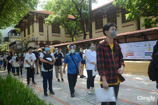 Thí sinh xếp hàng giãn cách để bước vào trường làm thủ tục thi
