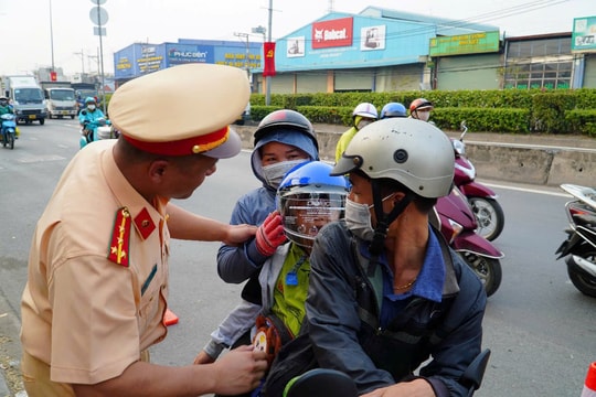 CSGT TP.HCM đội nắng điều tiết giao thông, tặng nước suối, khăn lạnh cho người dân về quê